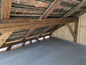 Reinforcement of the existing roof structure with reclaimed wood.